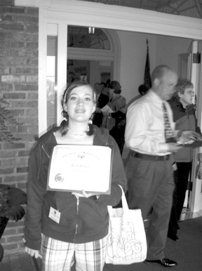 Brianna Pinckert stands in front of the Governor's mansion in Olympia after receiving her "Volunteer Service Award" for her work on a teen driving program.