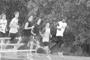 The boys cross country teams finish a 3.1-mile (5 kilometer) run on the South Whidbey High School track.