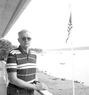 Jay Hall stands on his deck overlooking Holmes Harbor. After a 22-year career in the Air Force