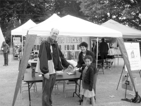 Matt Young and daughter Maria are purchasing some bucks at the booth at the farmer's market this weekend.