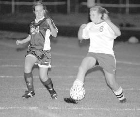 Ashley Poplawski works the ball forward in the Falcon JV’s victory Tuesday.