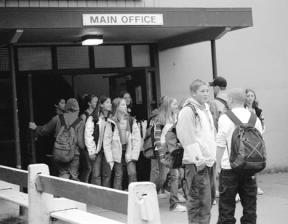 Students clog the courtyard at the Langley Middle School between classes. The school has cut down on passing times in recent years to reduce bullying.