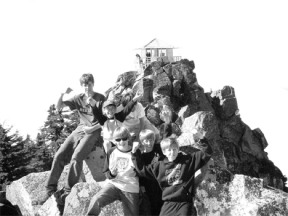 Eighth graders from Langley Middle School’s Adventure Education class climb up Mount Pilchuck. The fire lookout tower on the summit is in the background. Front row from left to right is Alex Wallace