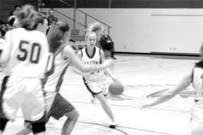 Junior Erica Johnson hurries the ball down court for an attempted layup during Tuesday's 51-31 spanking of the Falcons by undefeated Kings.