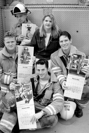 Firefighter calendar creator Tammi Spinner is surrounded by a few of her models