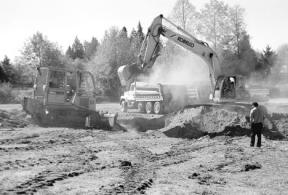 Employees of J & D Wallace General Contractors create a large hole at the Bayview corner