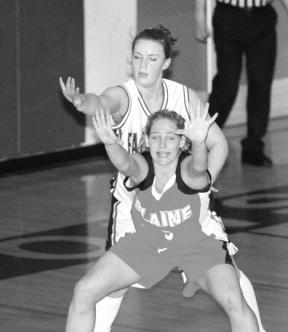 South Whidbey's Jordan Tobler reaches over Blaine guard Sheila Robertson to block her out under the net in the first quarter of Friday's 48-45 home overtime loss.