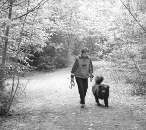 Vicki Payne and her dog Gizmo enjoy a walk Friday on a Department of Natural Resources trail in Goss Lake Woods.