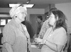 Mary Margaret Haugen talks with Brenda Ames of Pacific Northwest Bank after speaking at the Business After Hours mixer Thursday.