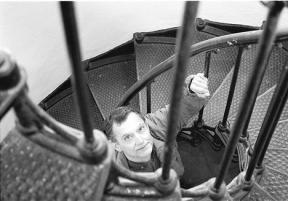 Artist and author Ray Aliberti climbs the tightly spiraling stairs to the top of Admiralty Head lighthouse. There are 31 steps in the metal staircase including the last few on a metal stepladder.