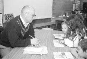 Reading specialist Jim Walker is the only full-time male teacher at the South Whidbey Primary School. He is the first- and second- grade reading specialist. Pictured here are first-graders Taylor Morley