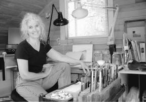 Patti Gulledge-White waits anxiously in her home painting studio to hear updated notice of her selection as a finalist for the national Arts for the Parks competition.