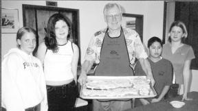 Dave Anderson shows off a plate of salmon served at a past dinner benefit for the South Whidbey Youth Center. This year’s dinner is Jan. 17 at Langley United Methodist Church.