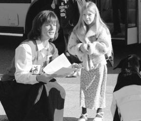 South Whidbey Primary School principal Bernie Mahar greets eager students curbside on the first day of school. Marla Shelton's dog