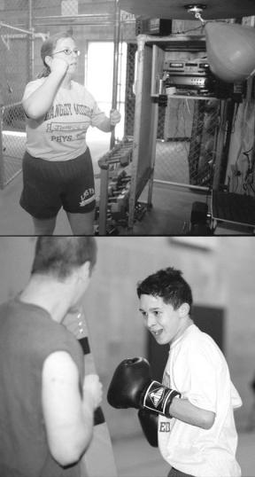 TOP: eighth grader Rhonda Johnson takes her turn at the speed bag. BELOW: Bobbo Sensano takes on a moving body bag during last week's boxing competition at Langley Middle School. The point of the drill was to land as many scoring power punches as possible.