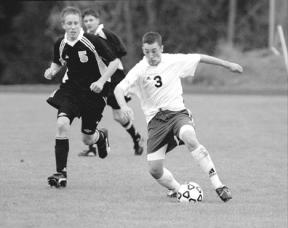 Sophomore Ben Walker takes the ball into striking range before lining up to make the Falcons' second goal of the day Saturday.