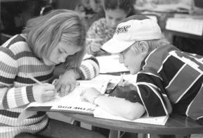 Langley Middle School sixth-grader Trevor Hein helps Mckenna Scoggins and Aliah Rasmussen with math problems during Homework Club at the middle school. Eleven students and three tutors showed up for LMS’s Homework Club Oct. 22.