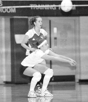 Senior Bronwyn Russell digs the ball out of the back court with junior Amy Brown standing by as backup during a match against Lynden Christian Saturday. Despite stellar games by Russell and senior Katy McGillen