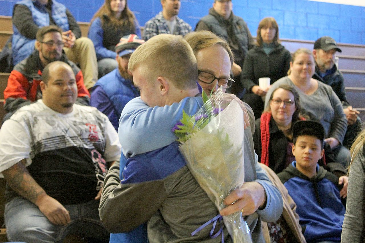 Evan Thompson / The Record —                                South Whidbey head wrestling coach Jim Thompson hugs senior Hunter Newman prior to the Falcons’ senior night match against Granite Falls on Jan. 11 at Erickson Gymnasium.