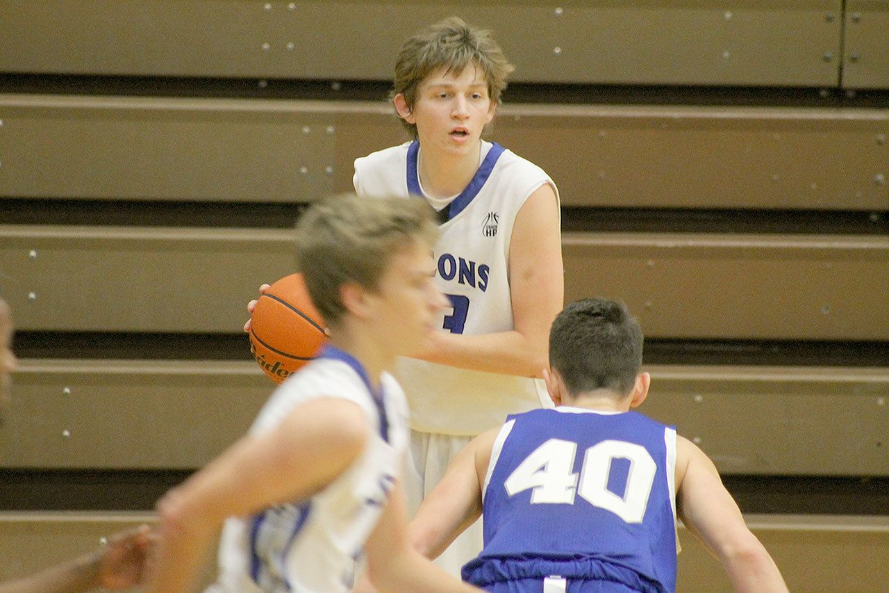 Evan Thompson / The Record — South Whidbey senior Kellen Boyd looks for an open Falcon player during a game against Bellevue Christian on Dec. 3. Boyd injured his ankle in a game on Jan. 17 and is questionable to play an important game for the Falcons this Friday night against Cedar Park Christian.