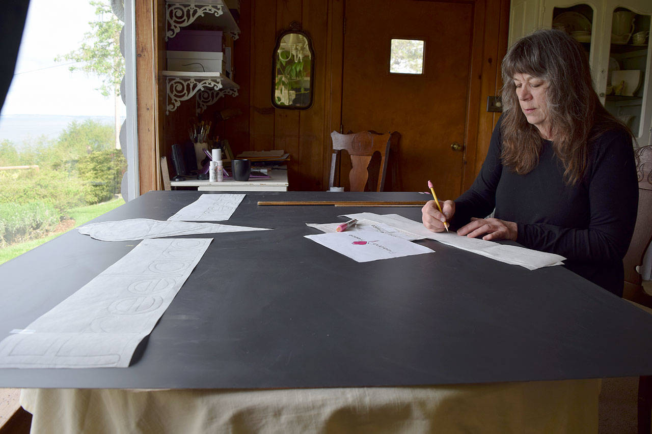 Kyle Jensen / The Record — Freeland resident Nora Harrell, also known as “the sign lady,” works on a sign for a new ice cream shop called Freeland Freeze.