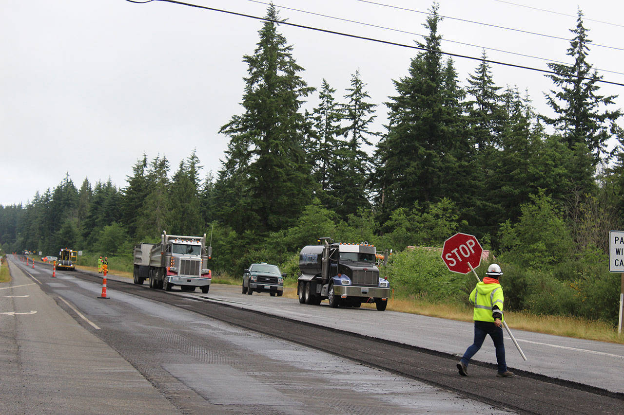 Road crews will be out all summer repaving more than 30 miles of Highway 525/State 20 from Coupeville to Clinton. Drivers should allow an extra 30 minutes for their trips and to catch ferries. Crews worked near the intersection of Classic Road and HIghway 525 Tuesday morning putting down new asphalt. Photo by Patricia Guthrie/South Whidbey Record