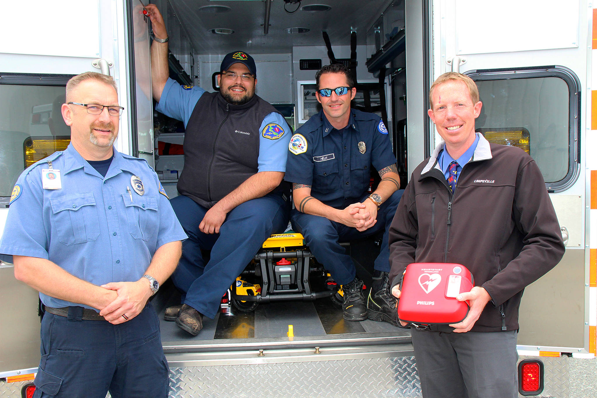 Jessie Stensland / Whidbey News Group                                From left to right are Gregory Behan, an EMT with WhidbeyHealth, Scott Jackson, a paramedic with the hospital, South Whidbey firefighter and Coupeville teacher Jon Gabelein and Capt. Jerry Helm with Coupeville Fire & Rescue.