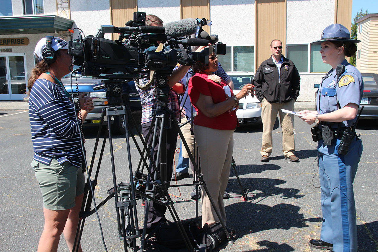 Washington State Trooper Heather Axtman speaks with TV reporters about an officer-involved shooting in Oak Harbor. Oak Harbor Police Chief Kevin Dresker is in the background.