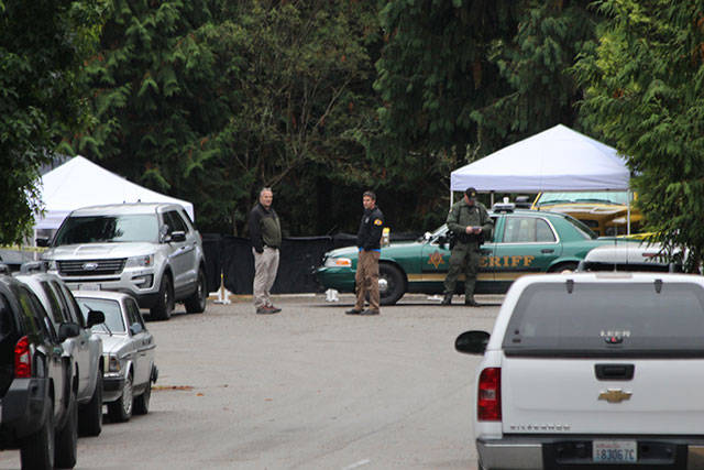 Jessie Stensland / Whidbey News-Times                                Officers gather at the site of an officer-involved shooting on North Whidbey that occurred Sunday night.