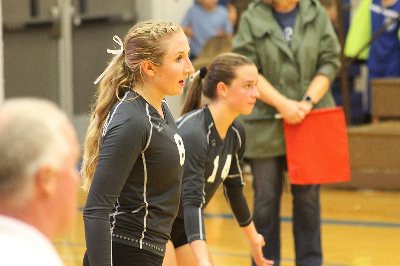 Evan Thompson / The Record — South Whidbey seniors Kolby Heggenes (left) and Sophia Nielsen prepare for a serve by Archbishop Murphy on Thursday night at Erickson Gymnasium. The Falcons narrowly lost to the top-ranked Wildcats 3-2.