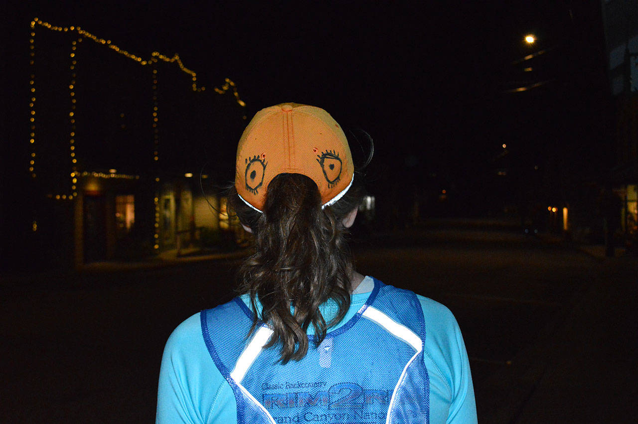 Julie Landau wears eyes on the back of her head early Wednesday morning. She made the alteration to her hat at the advice of a raptor expert to avoid being attacked by owls after it happened to her four times. Photo by Laura Guido/Whidbey News-Times