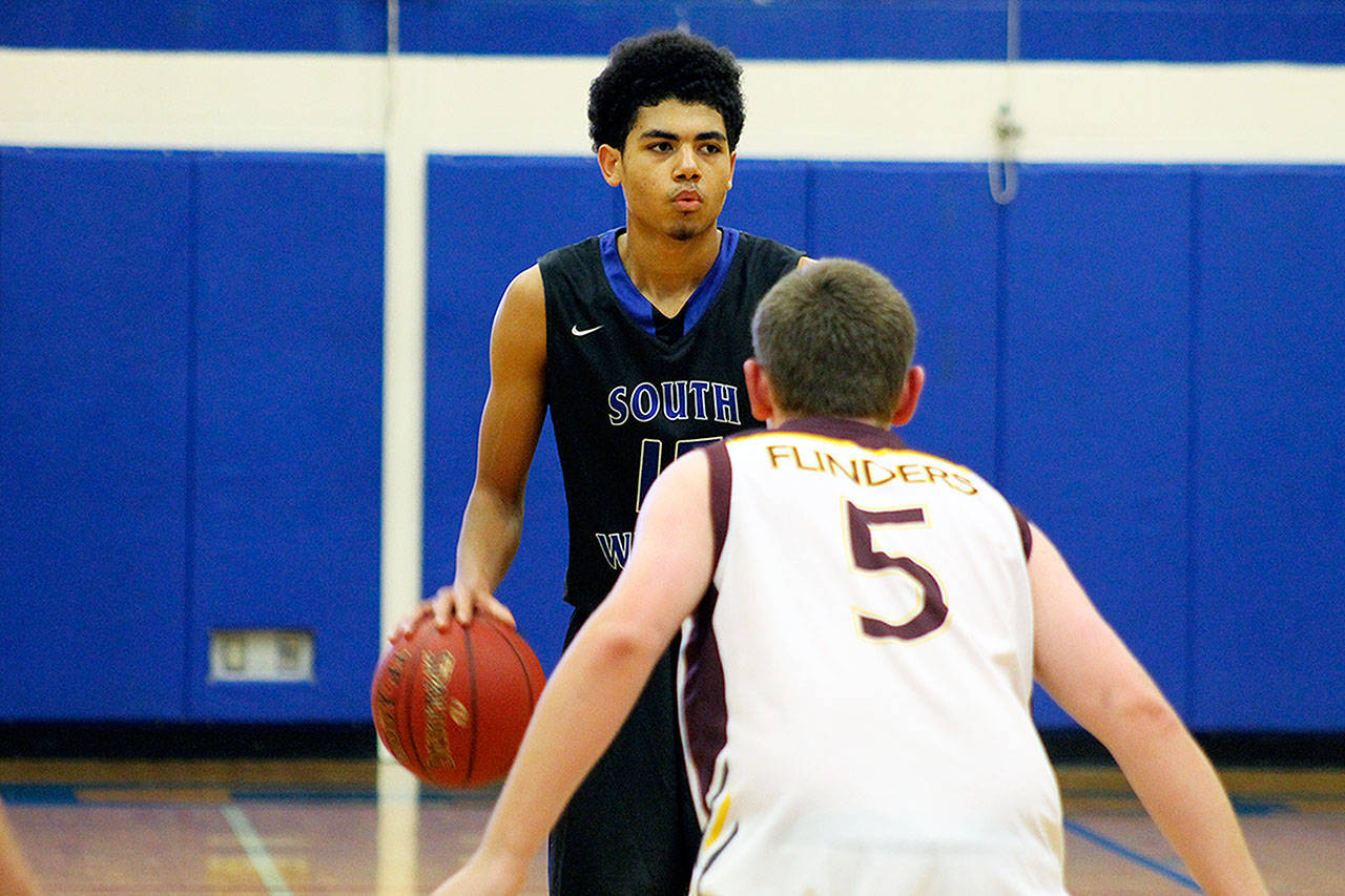 Evan Thompson / The Record — South Whidbey senior point guard Lewis Pope looks to exploit Flinders Christian School’s defense during the Falcons’ home game on Saturday at Erickson Gymnasium. Flinders came all the way from Australia to play South Whidbey.