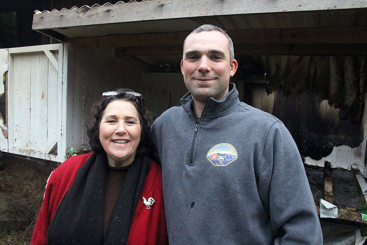 Evan Thompson / The Record — Erin Kelly (left) and Marc Swenson stand in front of the chicken coop that caught fire this past week when a heat lamp fell over. Swenson’s quick action prevented the fire from spreading to the rest of the house.