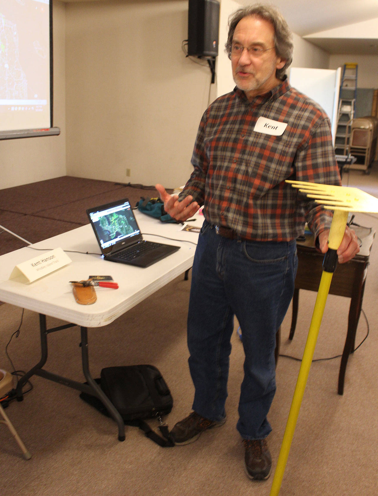 Kent Hanson shows off the two simple tools he says are needed to make hiking trails — a garden snip and a rake called a McLeod. Photo by Patricia Guthrie/Whidbey News-Group