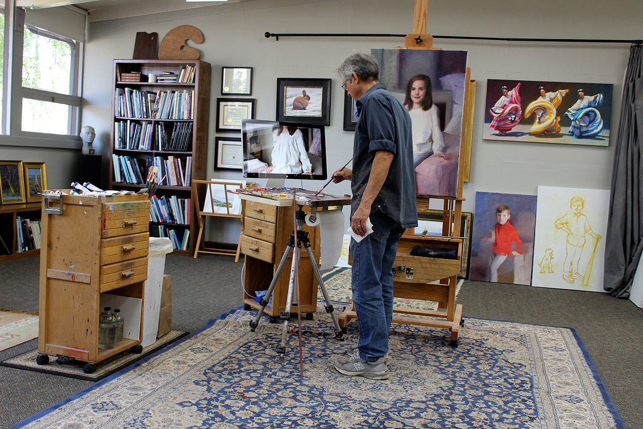 Painter James Tennison turned a former classroom at South Whidbey Community Center into a 1,000-square-foot combination studio, living room, library and place to teach art. Among the first tenant to lease, he calls the space “wonderful” and wonderfully close to his home in Langley. “It’s a two-minute walk away,” he said. (Photos by Patricia Guthrie/Whidbey News Group)