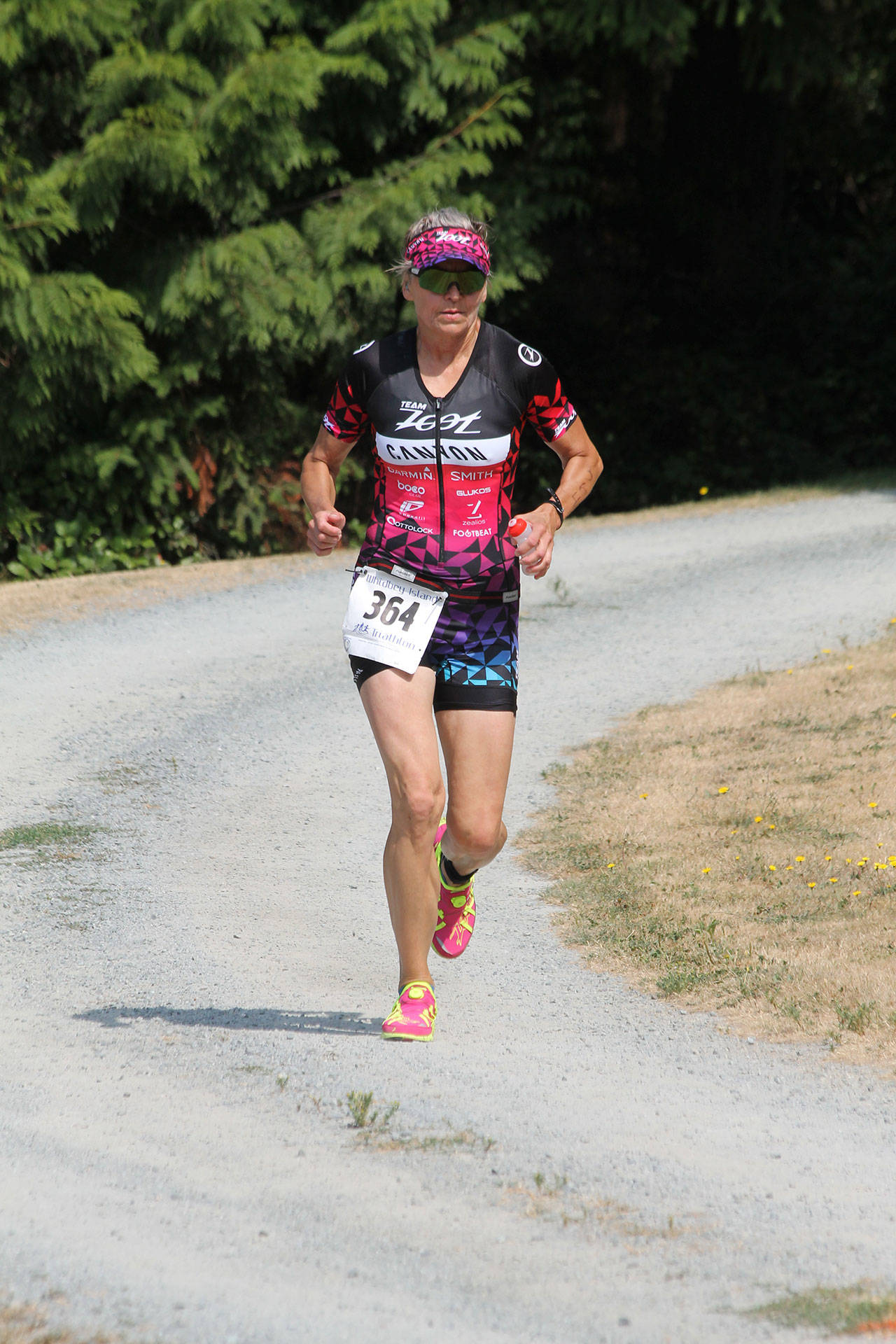 Christina Bromme runs through the trails of Langley’s Community Park during last weekend’s Whidbey Island Triathlon. (Photo by Jim Waller/Sound Whidbey Record)