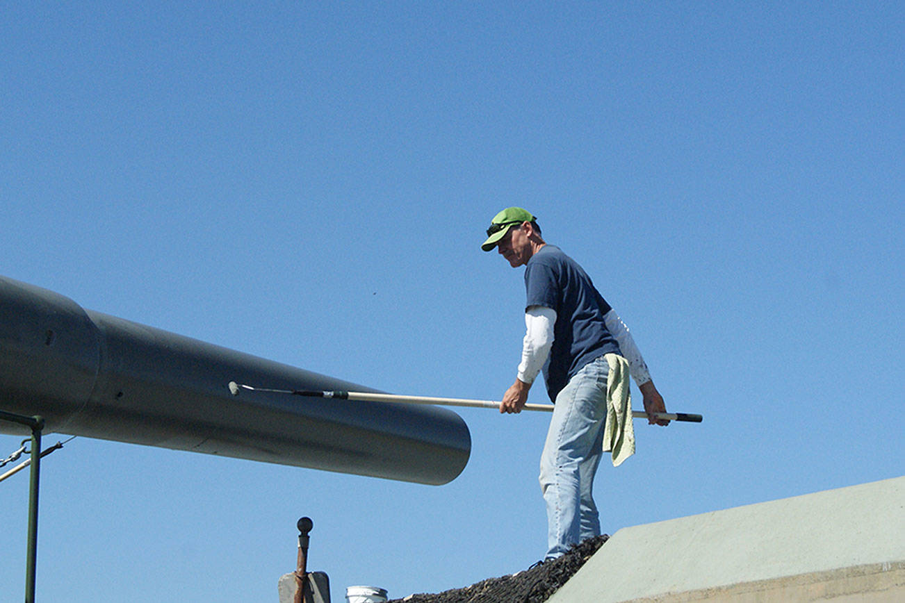 Photos by Maria Matson/Whidbey News Group                                John White of Freeland works to paint the “Big Guns” at Fort Casey. It was a good day to paint, with the sunshine and fresh air, he said. The work is being done by volunteers in preparation of the 50th anniversary of the “Big Guns” arrival, which will be held on Aug. 11.