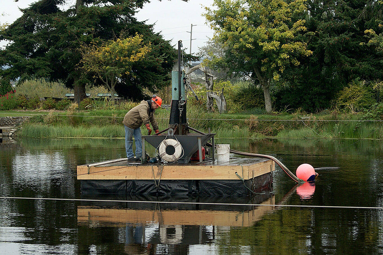 Photo by Maria Matson / Whidbey News Group                                Mike Brown runs the machine that is extracting goose and duck poop from the bottom of the Greenbank Farm pond.