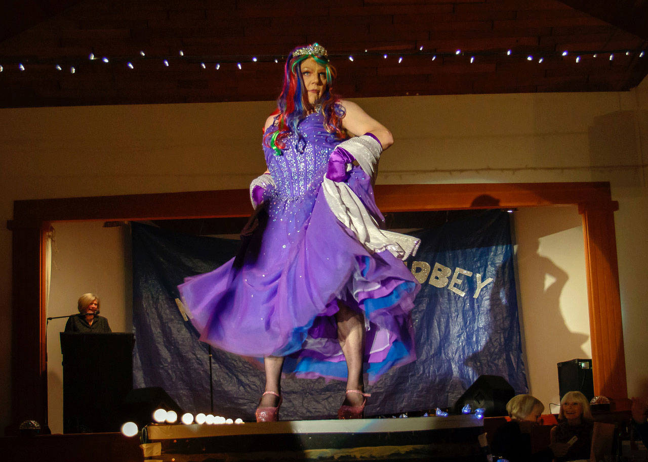 Mr. South Whidbey 2018, Larry Johnson, appearing as Ms. Sharlamaine Event, struts the stage in pink sparkling pumps. (Photo provided)