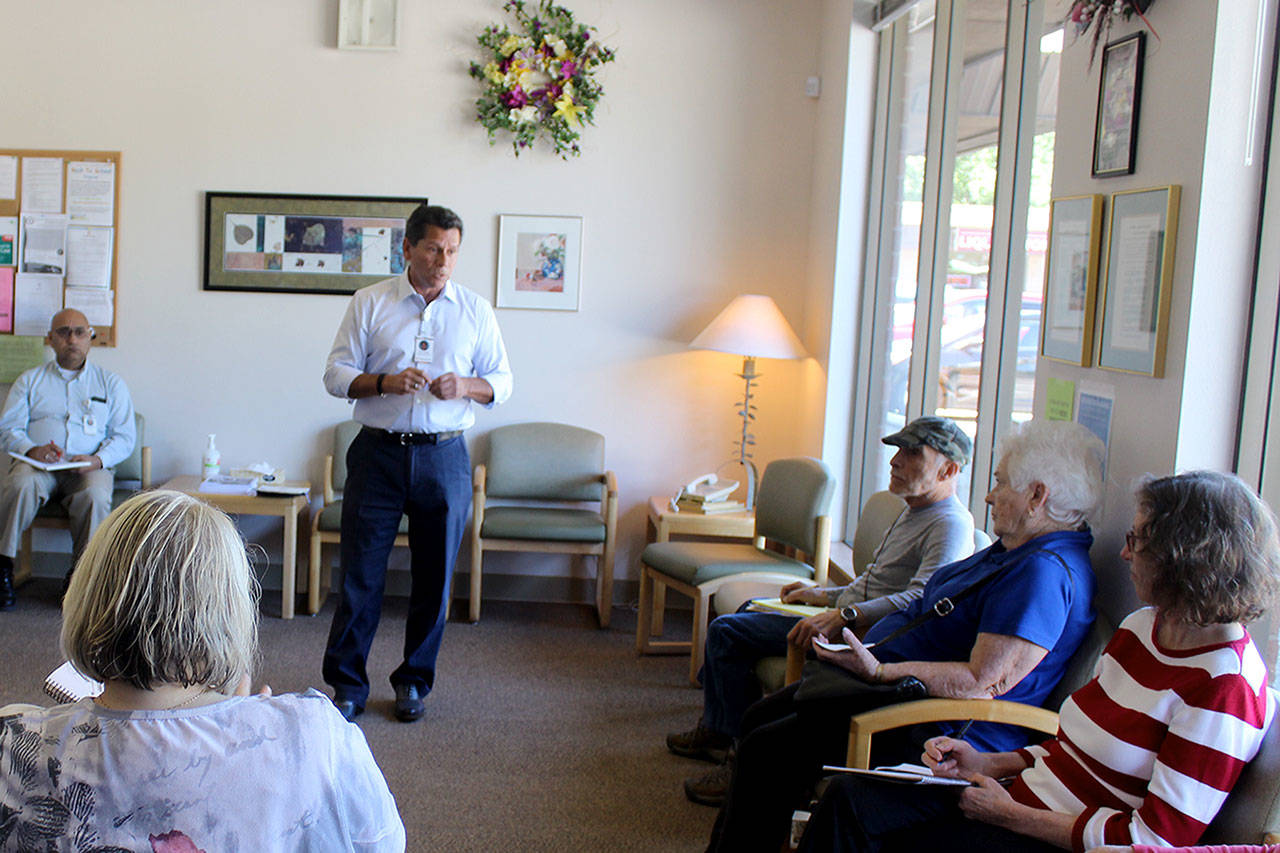 WhidbeyHealth CEO Ron Telles answers questions about the switch in services at the Clinton Clinic. Many longtime patients expressed anger that the healthcare system didn’t notify them that primary care services were being dropped May 30. Photo by Patricia Guthrie/Whidbey News Group