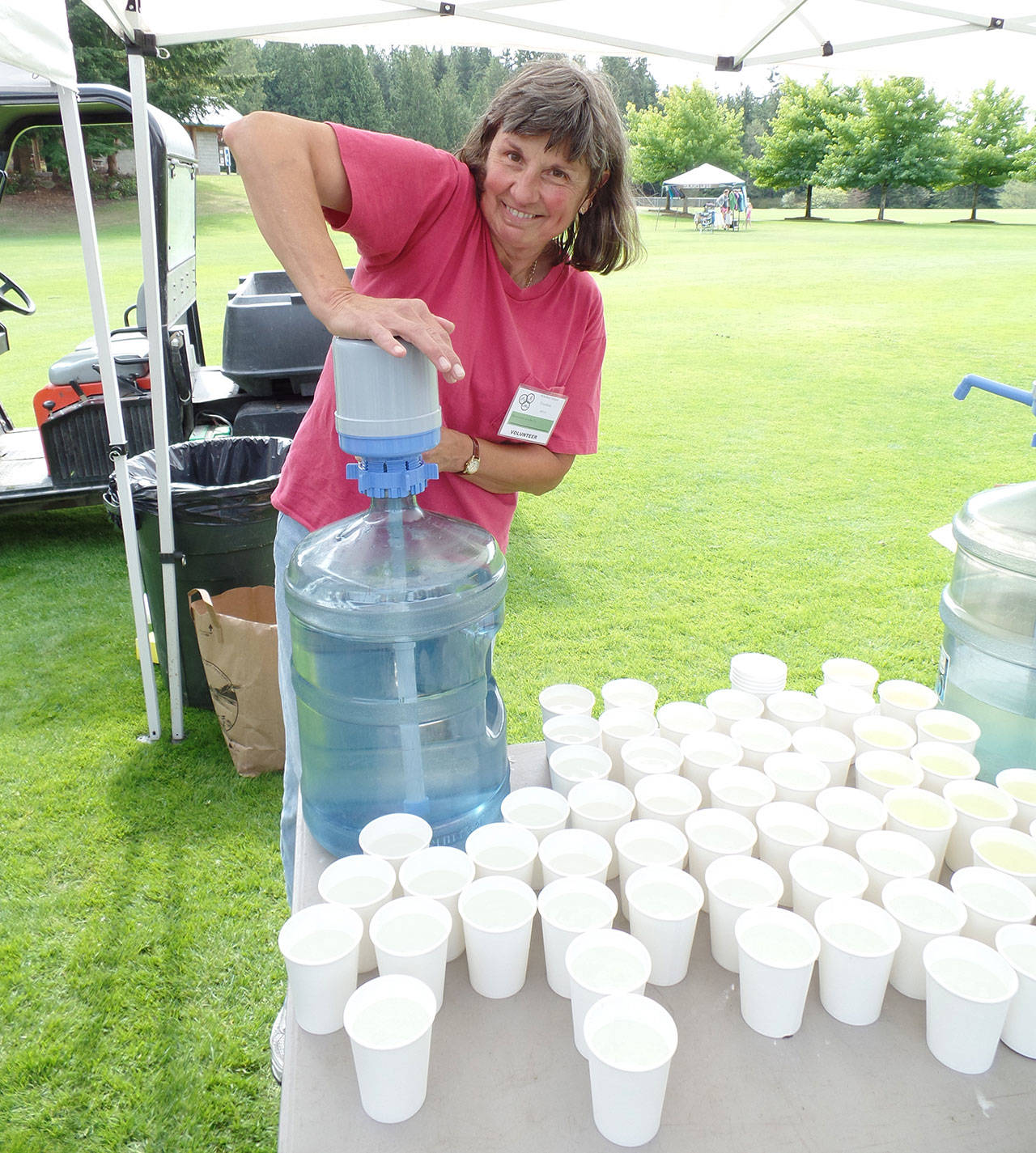 The South Whidbey Parks and Recreation District is seeking volunteers to help out with this year’s triathlon. Above, Susan Hamilton lends a hand at a past triathlon. (Submitted photo)