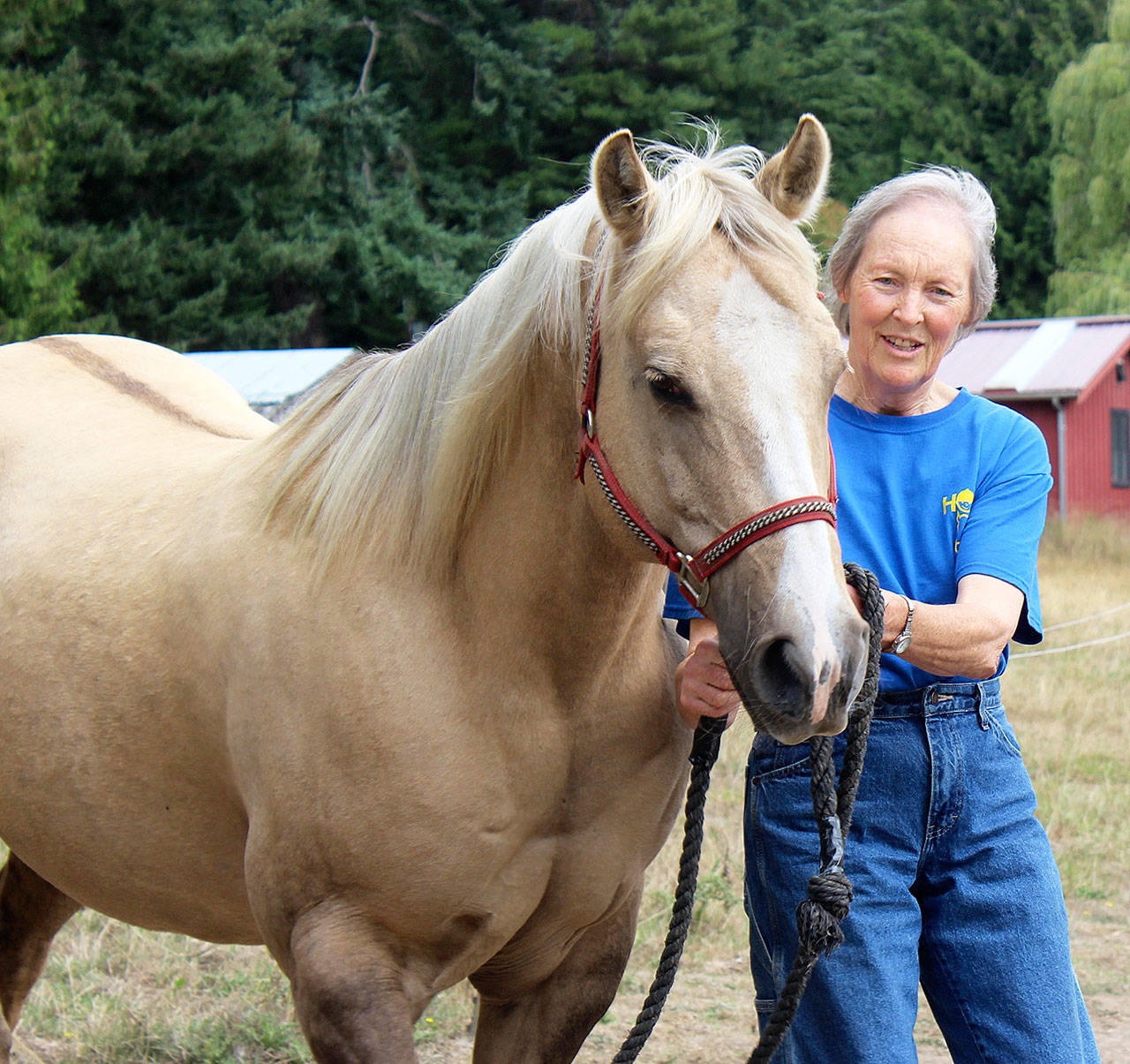 Vicky Howard, a board member at HOPE foundation, takes Bailey for a walk. Photo by Wendy Leigh/South Whidbey Record