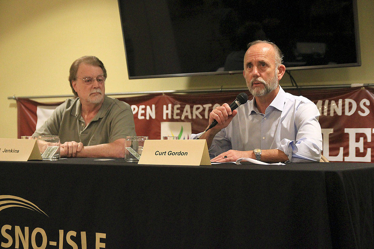 Photos by Laura Guido/ South Whidbey Record                                Port of South Whidbey Commissioner Curt Gordon, right, answers questions next to challenger Ed Jenkins Tuesday night at the League of Women Voters forum in Langley.