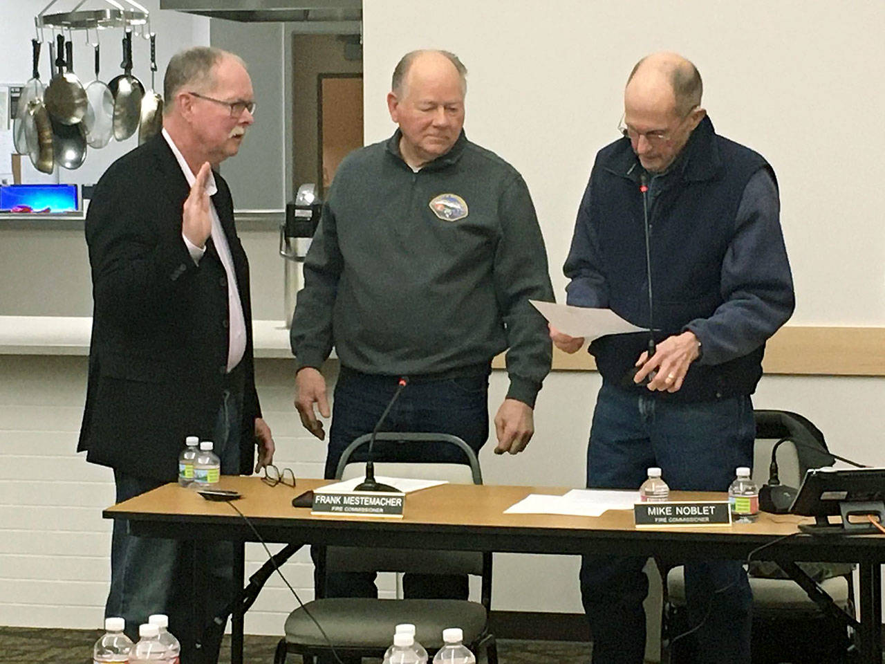 Photo provided                                New South Whidbey Fire/EMS Commissioner Lawrence Metz is sworn in by current commissioners Frank Mestemacher and Mike Noblet.