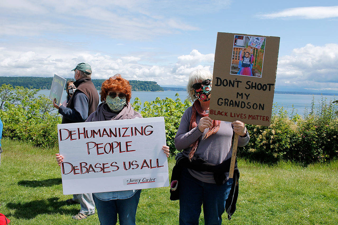 Photo by Kira Erickson/Whidbey News Group                                Clinton resident Claudia Fuller, right, and Freeland resident Rebecca Rickabaugh. Fuller holds a sign with a picture of her three-year-old grandson Elijah that says “Don’t shoot my grandson. Black Lives Matter.”