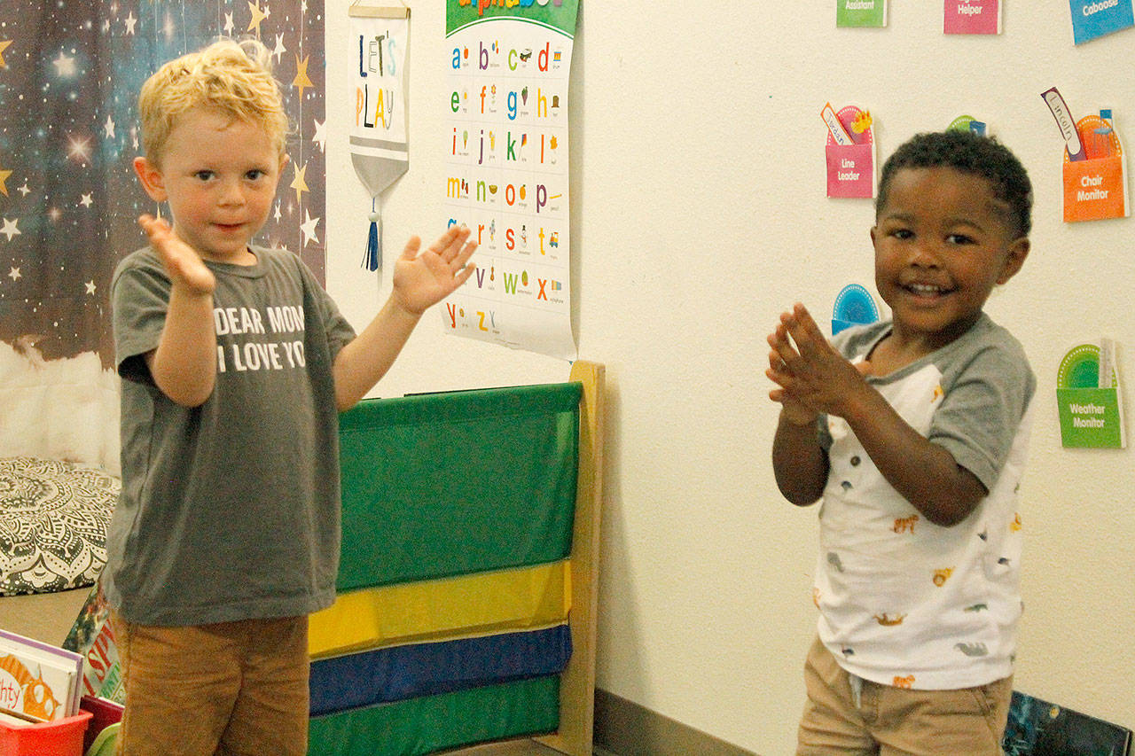 Lincoln Fresch, left, and Quintarius Eaves “clap the sillies out” during song time at Little Oaks Preschool & Childcare Center. Photo by Kira Erickson/Whidbey News Group.