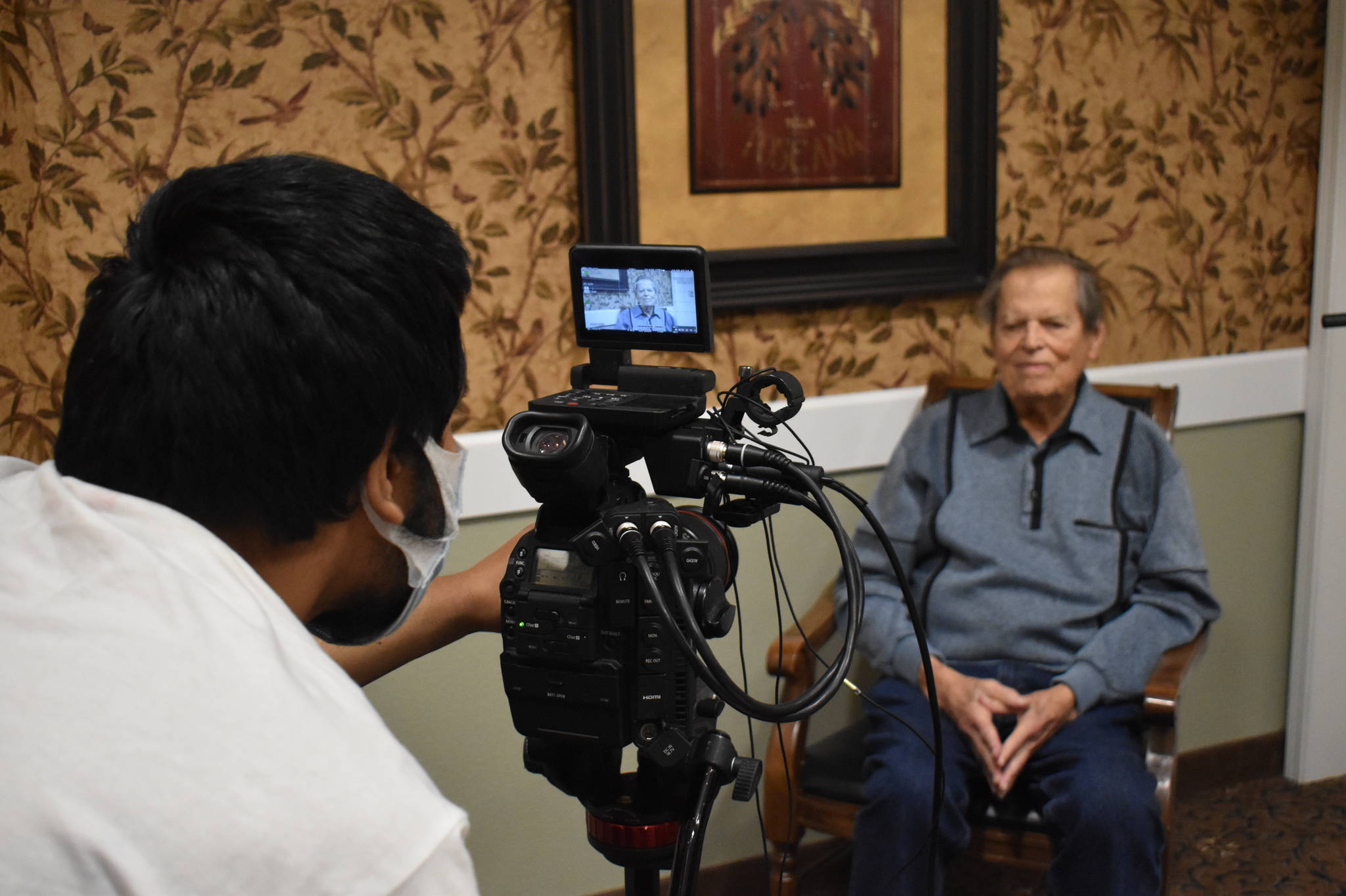 Rishi Sharma checks levels in his camera before interviewing WWII combat veteran Frank Burns of Freeland last Saturday. Sharma travels the country interviewing WWII combat veterans for his oral history project and nonprofit, Heroes of the Second World War. Photo by Emily Gilbert/Whidbey News-Times