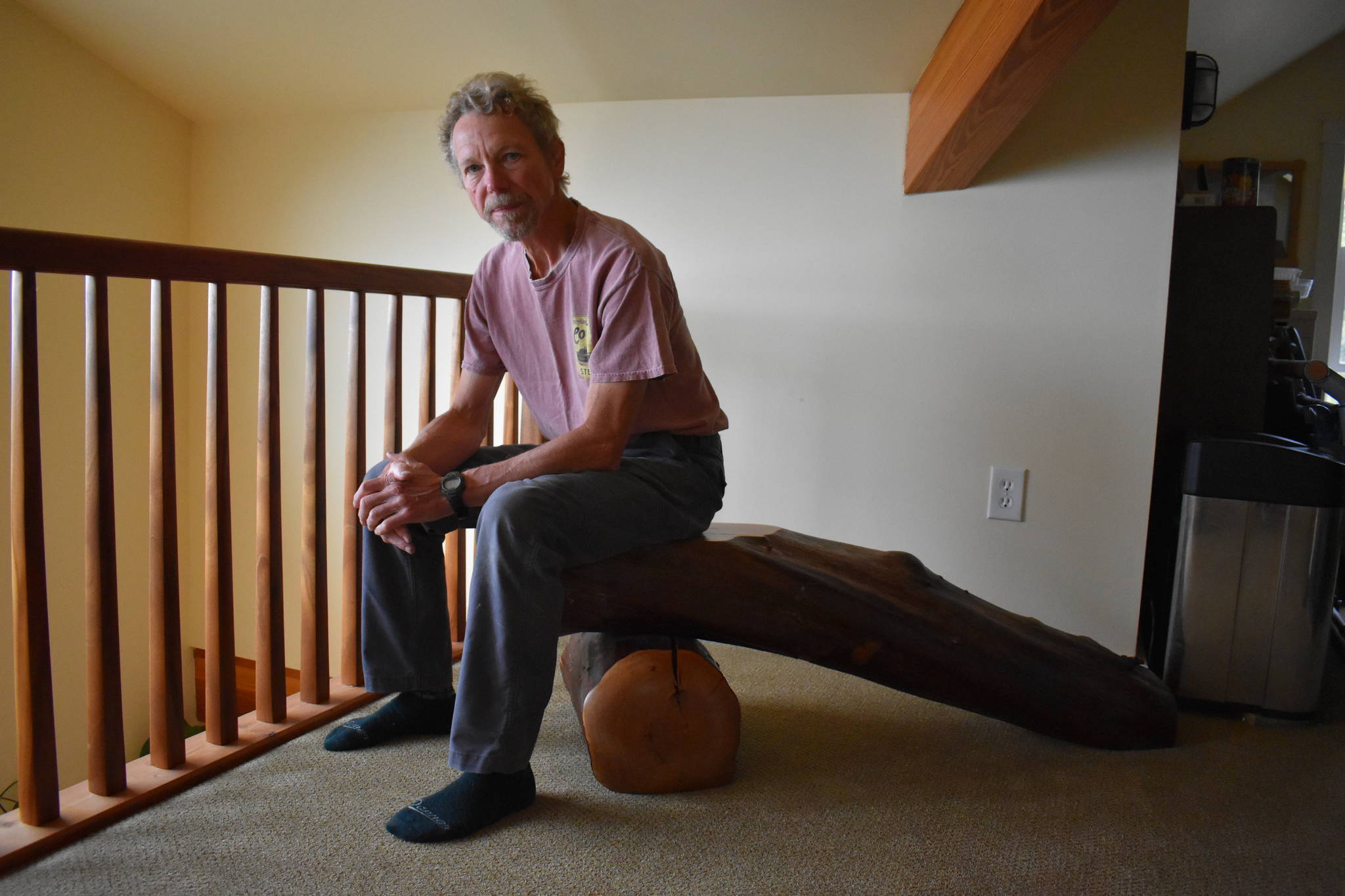 Photo by Emily Gilbert/Whidbey News-Times
Karl Nielsen sits on a log bench of his creation. The Oak Harbor resident will be bringing his work to Woodpalooza, a show for woodworkers taking place next weekend.