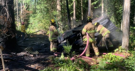 Photo provided
Firefighters from South Whidbey Fire/EMS responded Sunday to a fire in the woods behind the Bayview Cemetery.