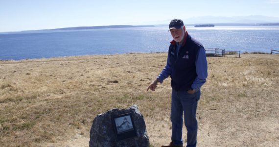 Photo by Rachel Rosen/Whidbey News-Times
Wayne Clark, a volunteer docent at Fort Casey State Park, stands next to the the new boulder and plaque that marks the spot of the original lighthouse at Admiralty Head.